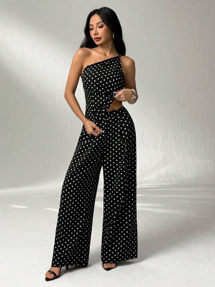 Black and white one-shoulder jumpsuit with polka dot print